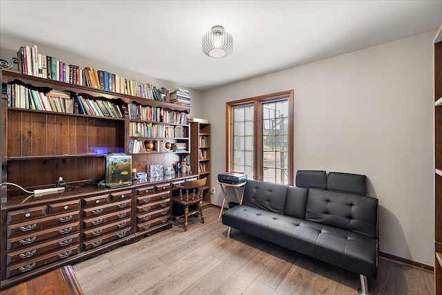 office featuring baseboards and light wood-style flooring