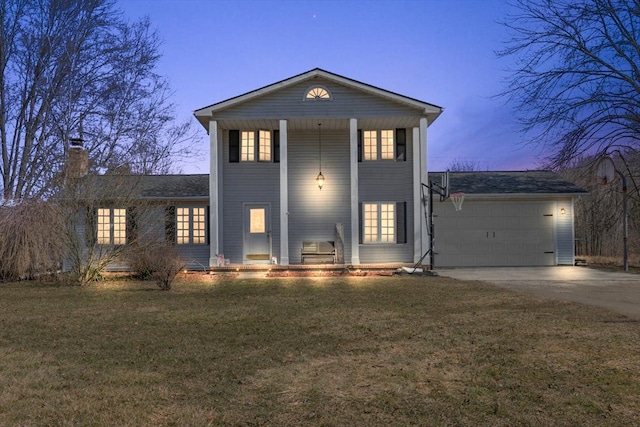 view of front facade with concrete driveway, an attached garage, and a front lawn