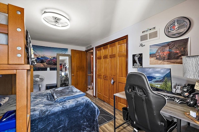 bedroom featuring wood finished floors and a closet