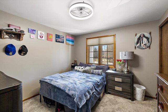 bedroom featuring baseboards and light carpet