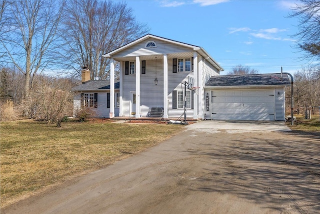 greek revival house featuring a front lawn, a garage, driveway, and a chimney