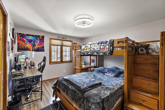 bedroom featuring baseboards and wood finished floors