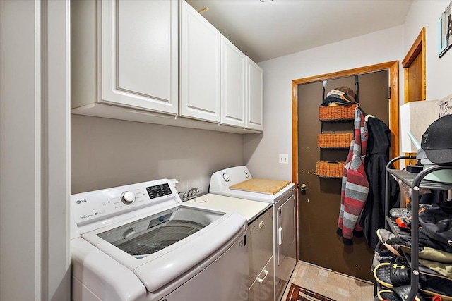 laundry area with cabinet space and independent washer and dryer