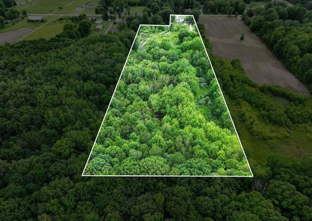 birds eye view of property with a wooded view