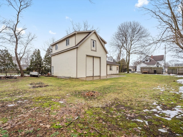 view of outbuilding featuring a garage and fence