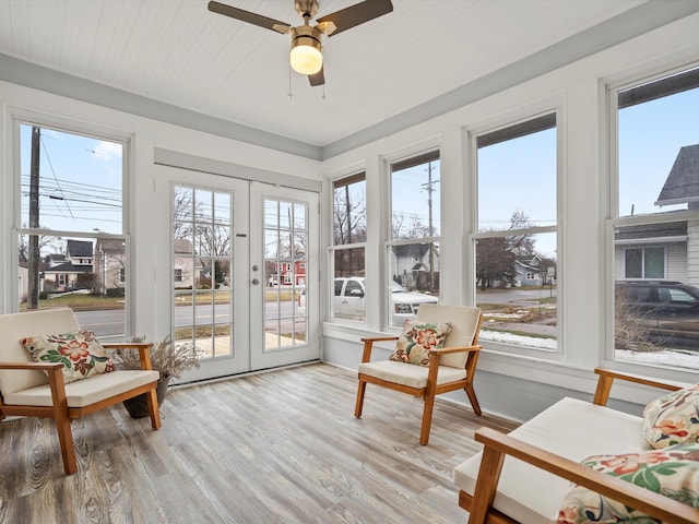 sunroom / solarium with french doors and a ceiling fan