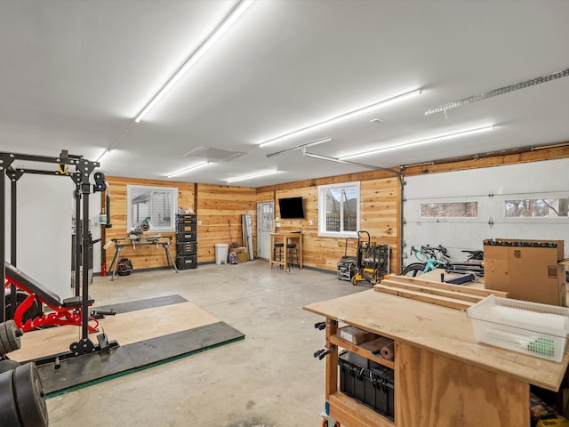 garage featuring a workshop area and wood walls