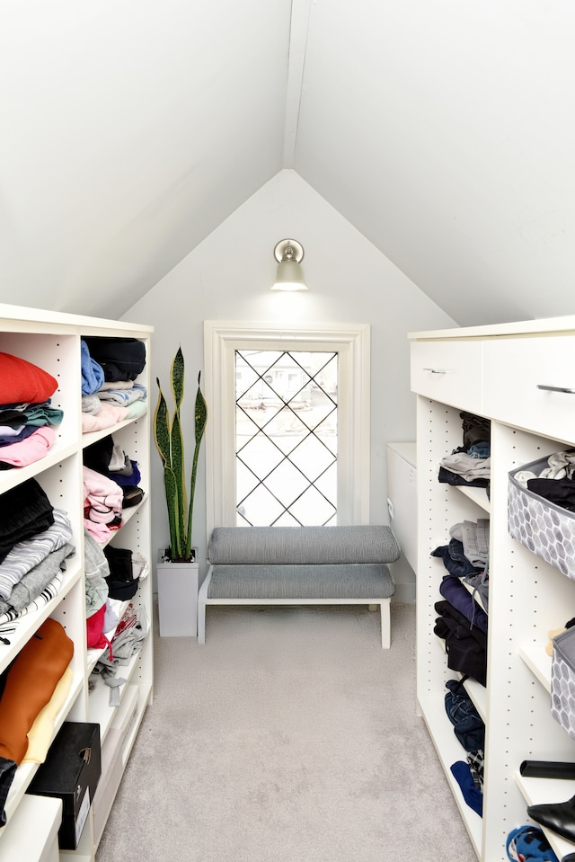 mudroom with carpet and vaulted ceiling