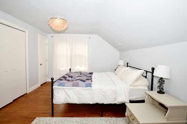 bedroom featuring lofted ceiling and light wood finished floors