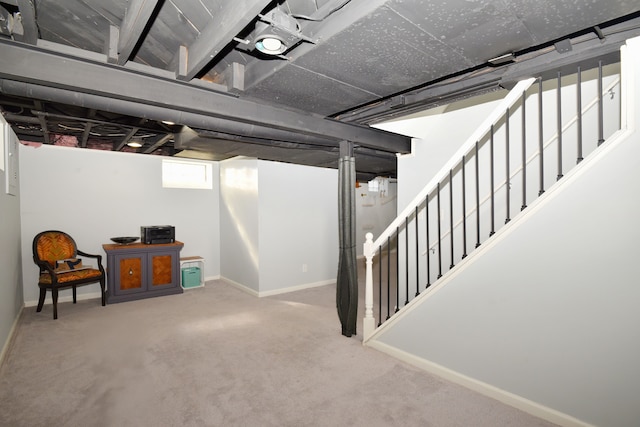 basement with stairs, carpet, and baseboards