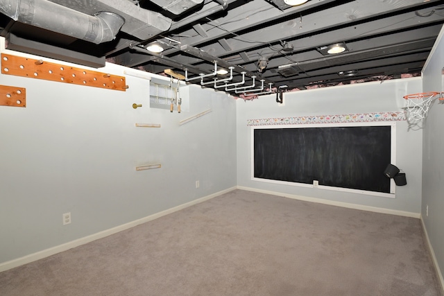 basement with baseboards and carpet