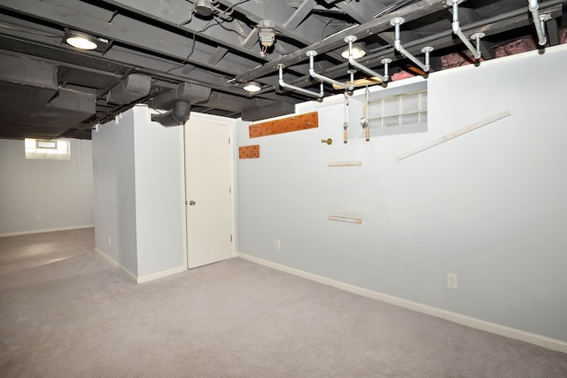 basement with carpet flooring and baseboards