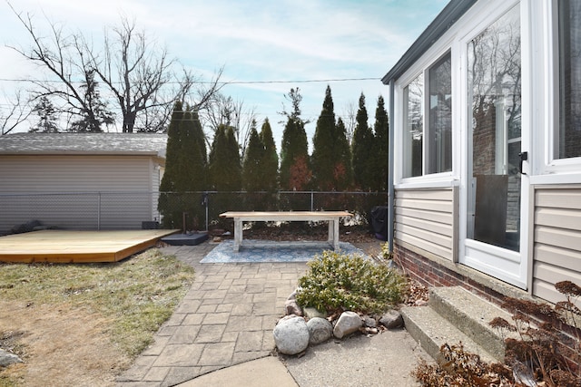 view of patio / terrace featuring a wooden deck and fence