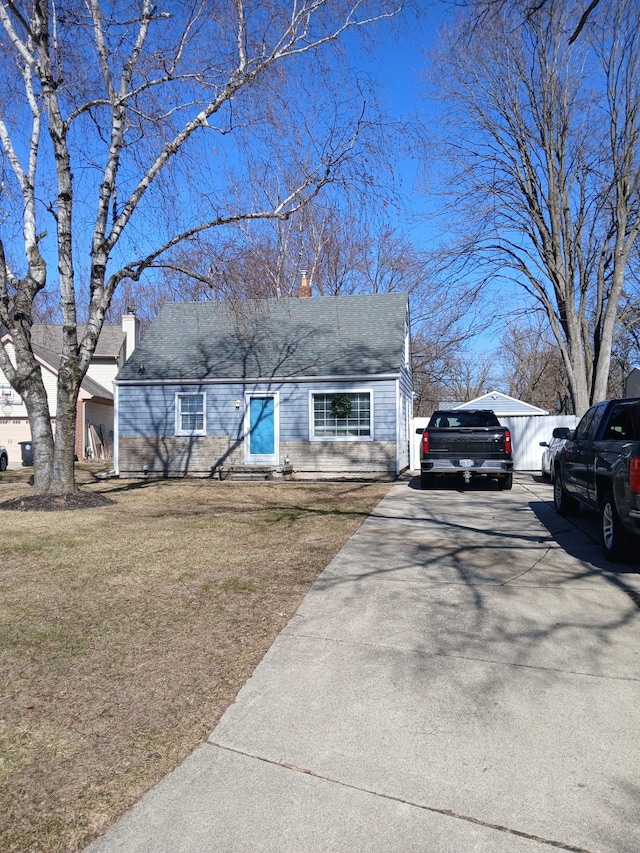 view of front of house featuring a front yard and a chimney