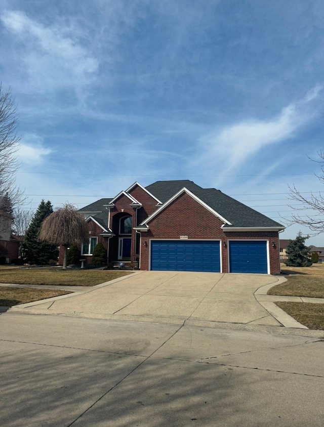 view of front of property with driveway, brick siding, and an attached garage