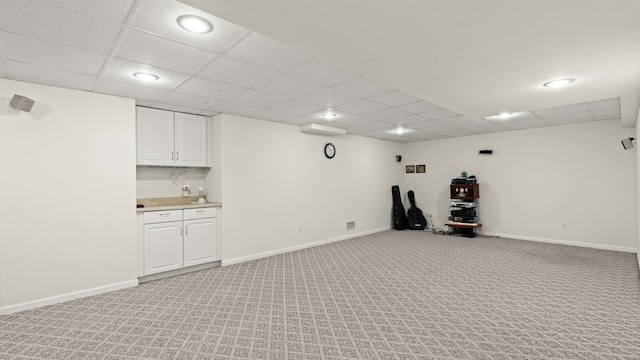 exercise area with light carpet, a drop ceiling, visible vents, and baseboards