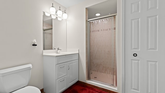 full bath with vanity, toilet, and a stall shower