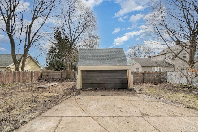 detached garage featuring fence