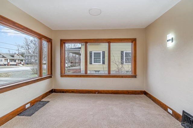 unfurnished sunroom with visible vents and a residential view