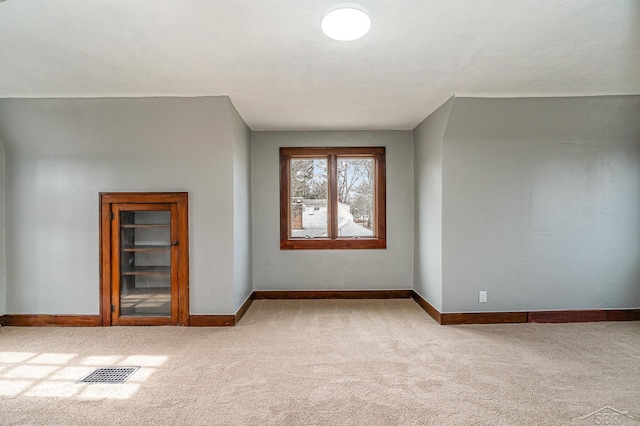 additional living space with visible vents, baseboards, and carpet