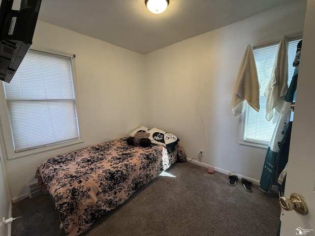 bedroom featuring baseboards, visible vents, and carpet floors