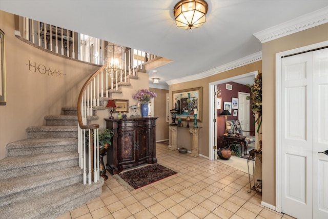 entryway featuring stairs, baseboards, light tile patterned flooring, and crown molding