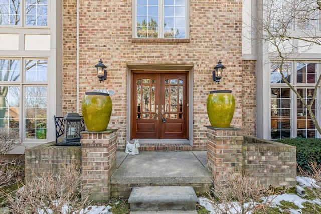 property entrance with french doors and brick siding