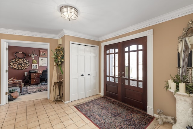 entryway featuring light tile patterned floors, french doors, baseboards, and ornamental molding