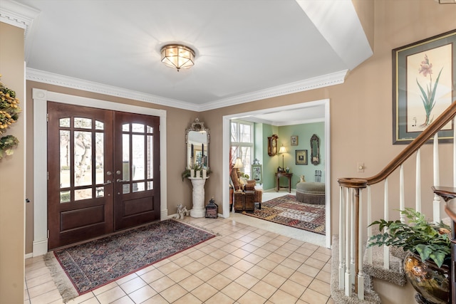 entryway with french doors, light tile patterned flooring, stairs, and ornamental molding