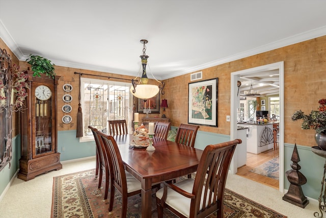 dining room featuring visible vents, carpet floors, and ornamental molding