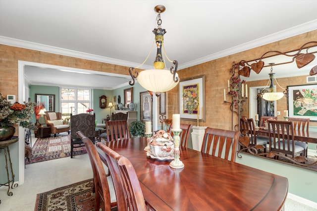 carpeted dining room featuring visible vents and crown molding