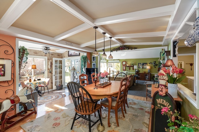 dining room featuring vaulted ceiling with beams, a ceiling fan, and wood finished floors