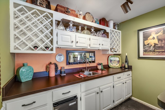 bar featuring indoor wet bar, baseboards, and a sink