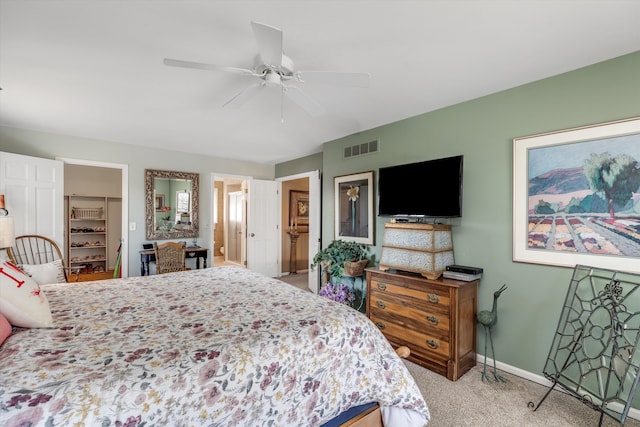 carpeted bedroom featuring visible vents, a closet, baseboards, ceiling fan, and a spacious closet