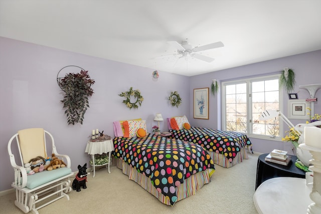 carpeted bedroom featuring a ceiling fan and baseboards