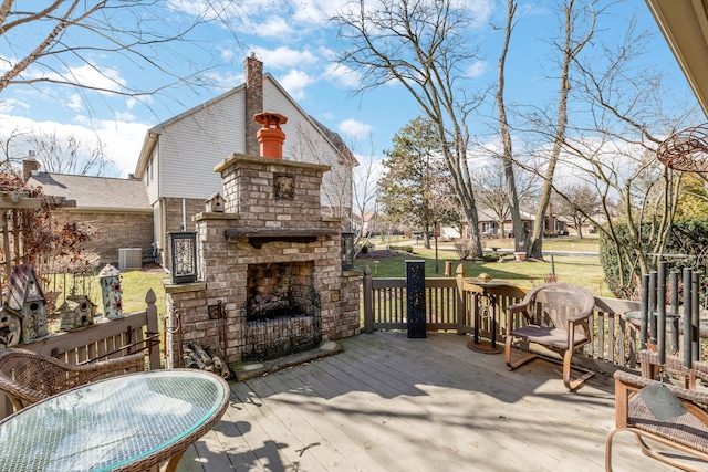 deck with an outdoor brick fireplace