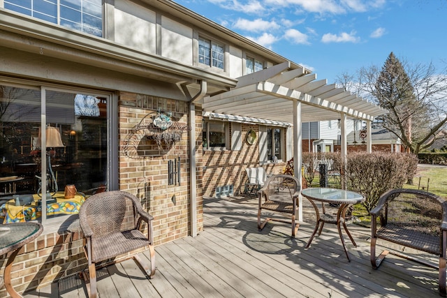 wooden deck featuring a pergola and outdoor dining area