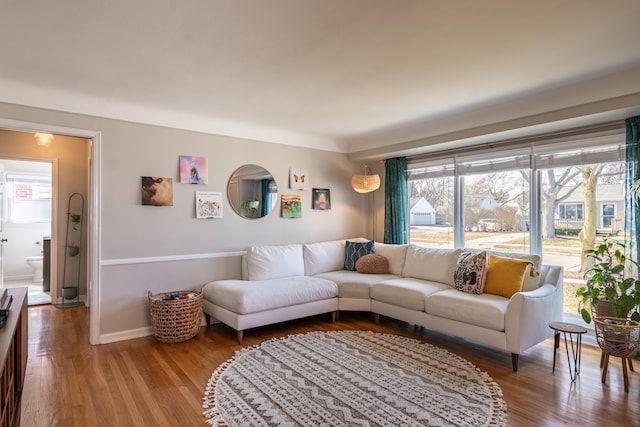 living room featuring baseboards and wood finished floors