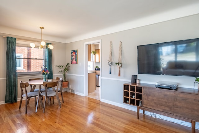 dining room with an inviting chandelier, wood finished floors, and baseboards