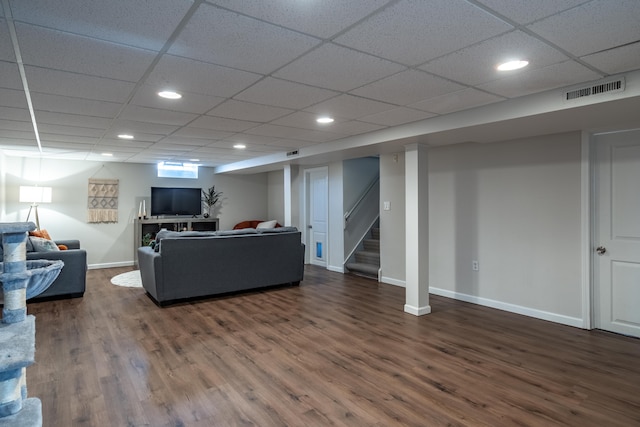 living area featuring visible vents, baseboards, stairs, recessed lighting, and wood finished floors