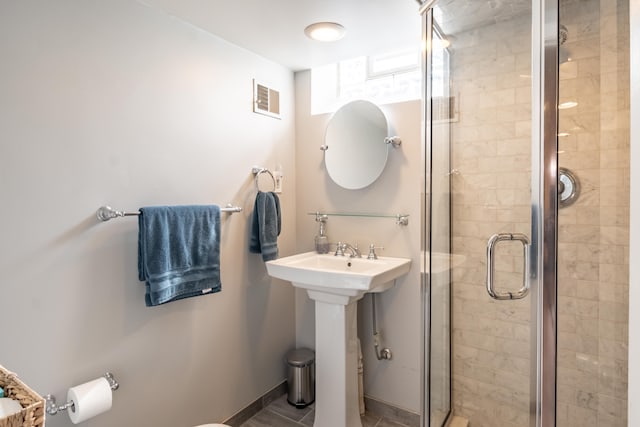 full bathroom with visible vents, a shower stall, and baseboards