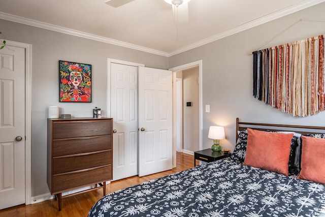 bedroom featuring ceiling fan, baseboards, wood finished floors, and crown molding