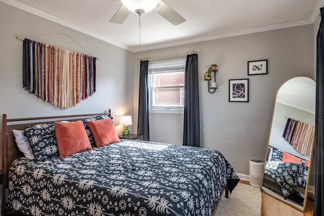 bedroom with baseboards, wood finished floors, ceiling fan, and ornamental molding