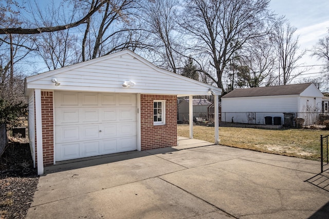 detached garage with driveway and fence