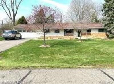 view of yard featuring aphalt driveway and a garage