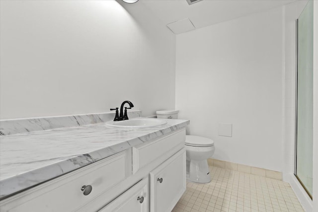 bathroom featuring vanity, baseboards, a shower with shower door, tile patterned floors, and toilet