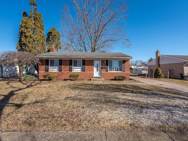 view of front of property with brick siding and a front lawn