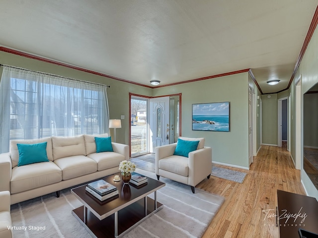 living room featuring light wood finished floors, baseboards, and ornamental molding