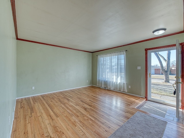 interior space with plenty of natural light, wood finished floors, and ornamental molding