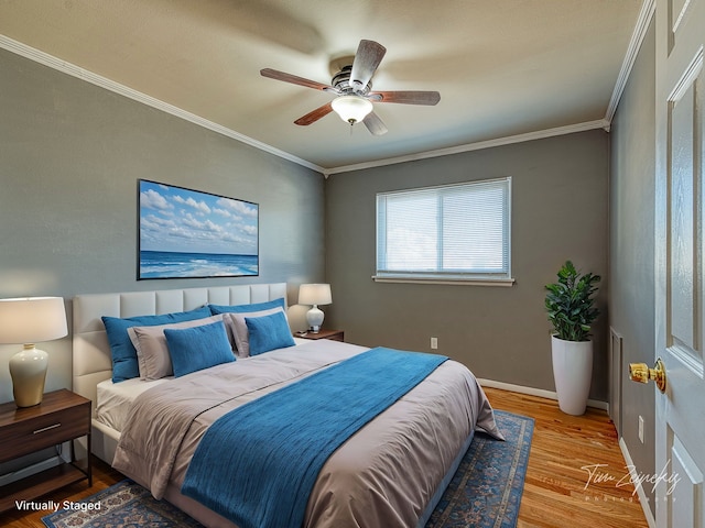 bedroom featuring ceiling fan, baseboards, wood finished floors, and ornamental molding